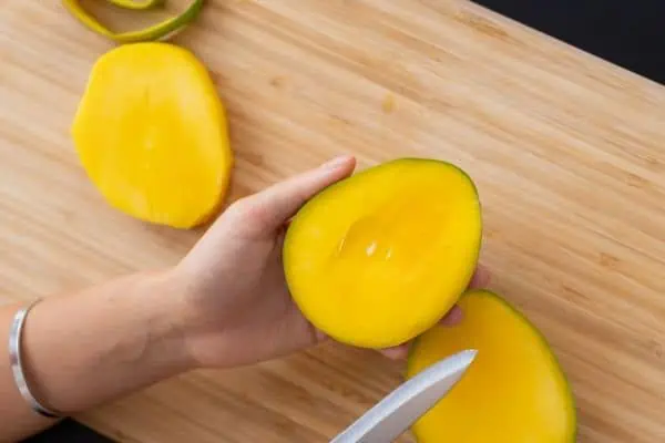 picture of a person cutting seasonal mangoes